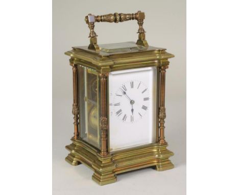 A BRASS CASED CARRIAGE CLOCK, the twin barrel movement with platform escapement repeat striking on a gong, white enamel dial 