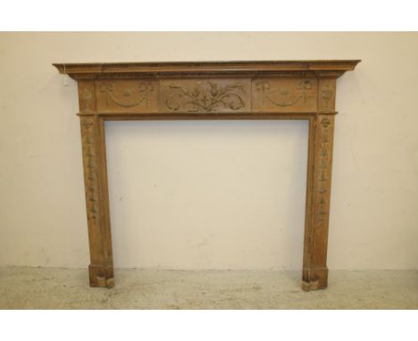 A PINE AND GESSO FIRE SURROUND of Georgian design, 19th century, the inverted breakfront shelf with leaf moulded edge, frieze