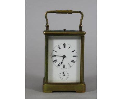 A FRENCH BRASS CARRIAGE CLOCK, the twin barrel movement with cylinder escapement repeat striking on a gong, white enamel dial