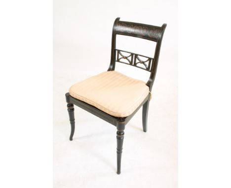 A REGENCY EBONISED AND PARCEL GILT SIDE CHAIR, c.1810, the straight top rail painted with foliate scrolls over a pierced trel