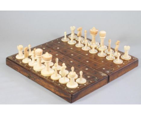 AN ANGLO INDIAN IVORY CHESS SET, late 19th century, all natural, one set with two turned and block stained rings to the bases