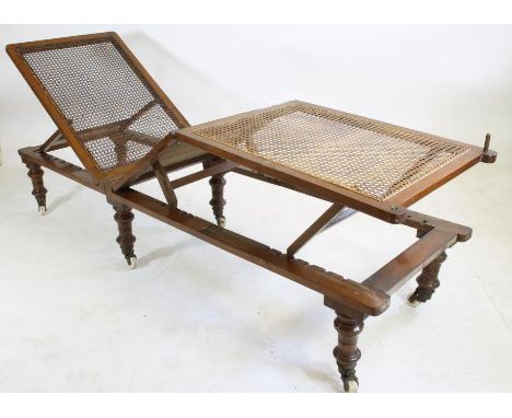 A VICTORIAN CARVED MAHOGANY ADJUSTABLE CAMPAIGN BED by Leveson (Manchester), raised on screw off turned tapering legs with br