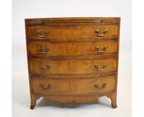 A SMALL REGENCY STYLE MAHOGANY CHEST OF DRAWERS, 20th century, of bowed form, crossbanded with stringing, caddy top, brushing
