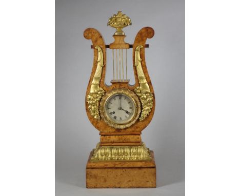 A FRENCH BURR MAPLE AND ORMOLU MANTEL CLOCK, c.1900, the twin barrel movement with later platform escapement striking on a be