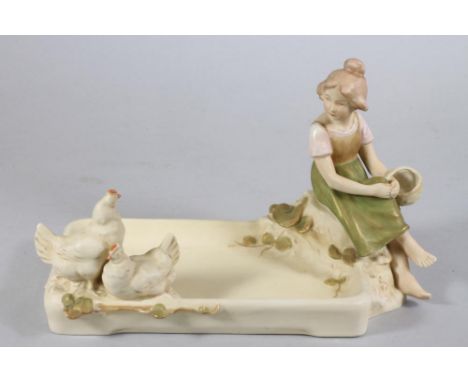 A ROYAL DUX ART NOUVEAU SMALL PORCELAIN FIGURAL CENTREPIECE, modelled as a young girl wearing a pink blouse and green skirt, 