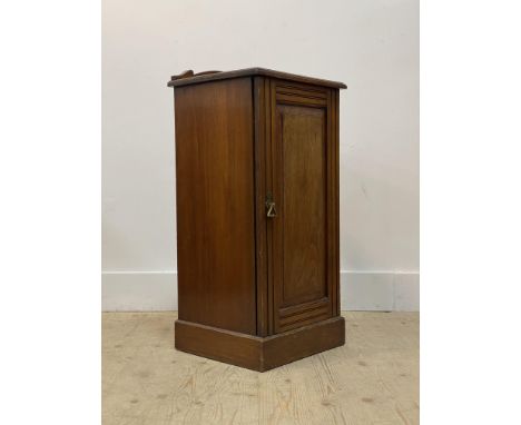 A early 20th century walnut bedside cupboard, the ledge back over panelled door enclosing a shelf, on a skirted base. H81cm, 