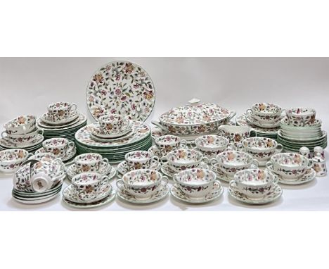 A Minton Haddon Hall pattern tea and dinner service comprising twelve China trios (teacup, saucer, tea plate), a milk jug, a 