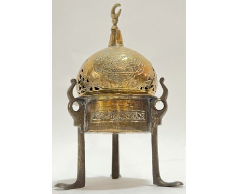 An Eastern brass tripod censer with chased Arabic inscriptions and crescent moon finial, possibly Sino-Islamic (h- 16cm)
