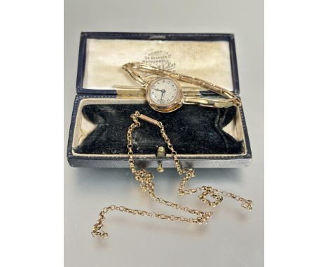 A vintage ladys 9ct gold wrist watch with silvered dial on expanding gilt metal bracelet a/f and a section of yellow metal be