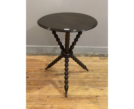 A late Victorian mahogany gipsy table, the circular moulded top raised on three bobbin turned supports. H65cm, D54cm.&nbsp;