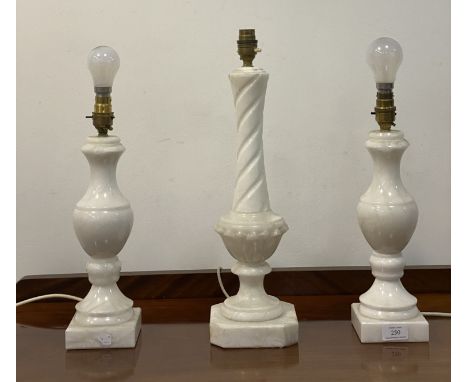 A pair of modern alabaster lamps of baluster form, (H39cm) together with a similar spiral moulded lamp (H49cm)