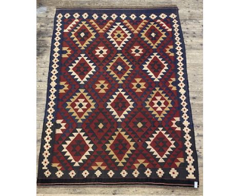 A Vintage kilim rug of all over geometric design (some splits) 275cm x 200cm.&nbsp;