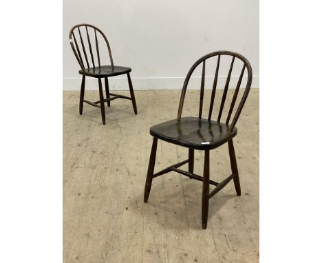 A pair of Vintage side chairs, each with hoop and spindle back over saddle seat, raised on turned supports. H80cm.&nbsp;