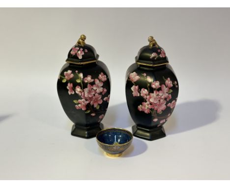 A pair of Carlton Ware Stroke on Trent baluster shaped vases on a black background with cherry blossom to centre with cover (