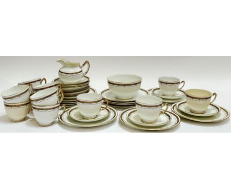 A Paragon China part tea service with Art Deco style gilt swag decoration and gilt rims comprising twelve cups, twelve tea pl