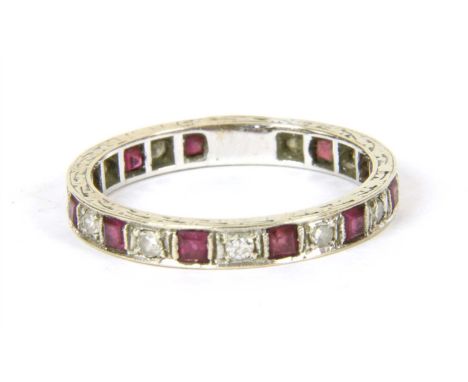 A white gold ruby and diamond eternity ring, tested as approximately 18ct white gold, finger size O, 2.83g