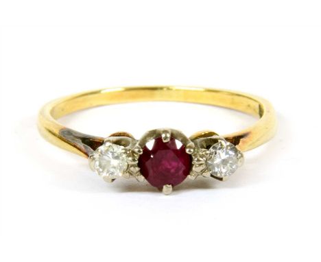 A three stone ruby and diamond ring, marked 18ct, finger size N¼, 2.43g