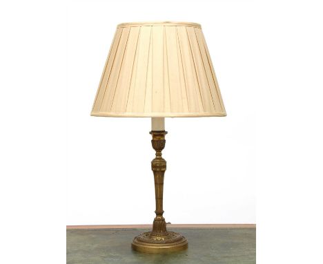 A brass candlestick table lamp, with cast neoclassical decoration and a silk shade, 58cm high, and a brass Corinthian column 