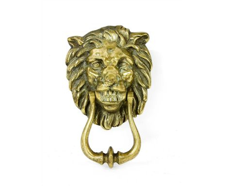 A brass door knocker in the form of a lion mask, having loop handle, 23cm high