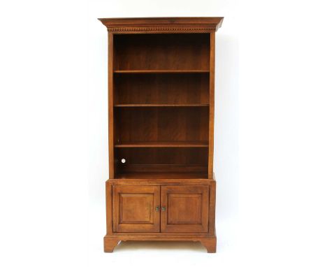 A Bob Timberlake American cherry bookcase, the moulded cornice top over an indented frieze over the open bookshelves over two