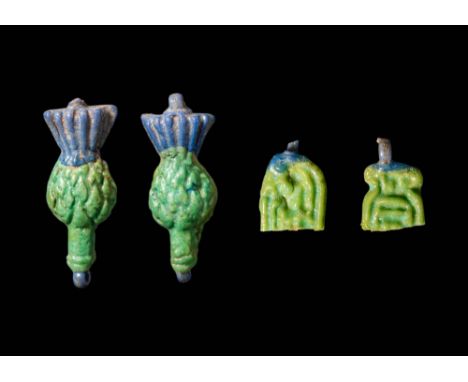 New Kingdom, Ca. 1550 - 1069 BC.A matched pair of cornflower pendants in glazed faience, each composed of a flaring blue caly
