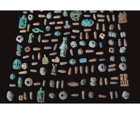 Ca. 1550 - 332 BC. A collection of faience pendants and beads, including a Sekhmet aegis, goddess Taweret shown in profile ho