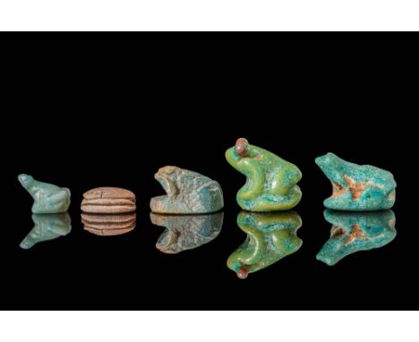 New Kingdom, Ca. 1550 - 1069 BC.A collection of four scaraboid frog amulets and one scarab, each pierced lengthwise through t