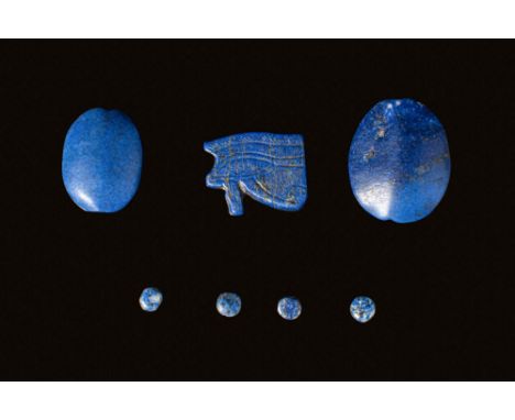 New Kingdom to Third Intermediate Period, Ca. 1550 - 664 BC. A collection of amulets and beads. The one on the left is a scar