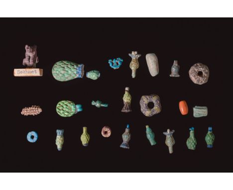 Ca. 1550 - 332 BC. A collection of 24 faience pendants and amulets, including an amulet of Sekhmet, numerous cornflower amule