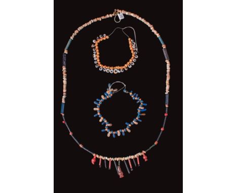 Late Period, Ca. 664 - 332 BC. A collection of three restrung strands of glass and faience beads. The longest strand consists