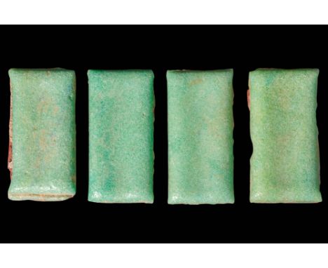 Old Kingdom, Ca. 2686 - 2181 BC. A collection of four rectangular faience tiles, each with a flat face, coated in a pale gree