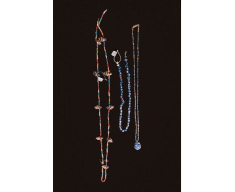 Ca. 600 - 300 BC. A collection of three restrung necklaces. The uppermost necklace consists of multicoloured small disc beads