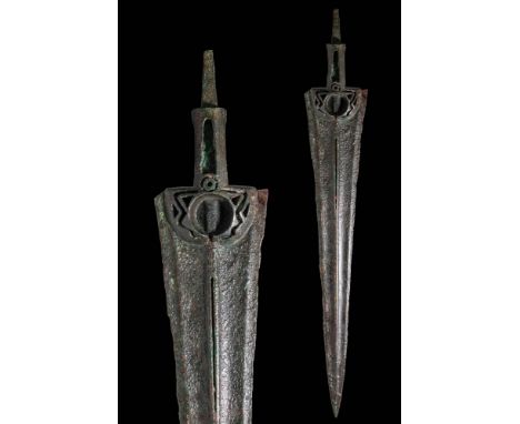 Ca. 1200 - 800 BC. A cast bronze spearhead with an elongated, triangular blade with a prominent midrib. It terminates in a cr