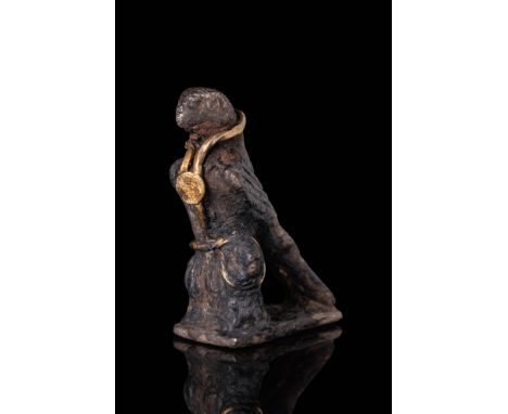 Ca. AD 200 - 400. A silver figurine of an eagle with wings folded along the back and body, perched on a rectangular base. The