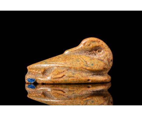 New Kingdom, Ca. 1550 - 1069 BC. A yellow faience scaraboid amulet in the form of a recumbent duck with its head turned back 