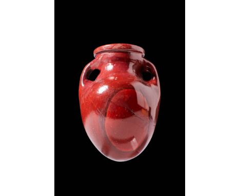 Ca. 300 - 100 BC.A red jasper amphoriskos with a slender neck, rounded body, and two delicate handles that curve from the rim