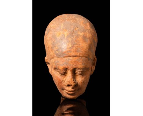 Late Period, Ca. 664 - 332 BC. A terracotta head of a male figure of elevated status, likely representing King Amasis. He wea