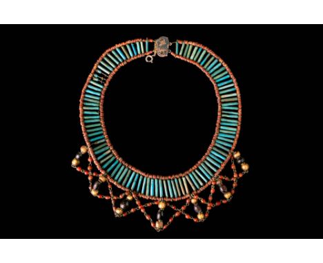 Ca. 1550 - 332 BC.A restrung broad collar necklace composed of a row of turquoise-blue faience tubular beads framed by small 