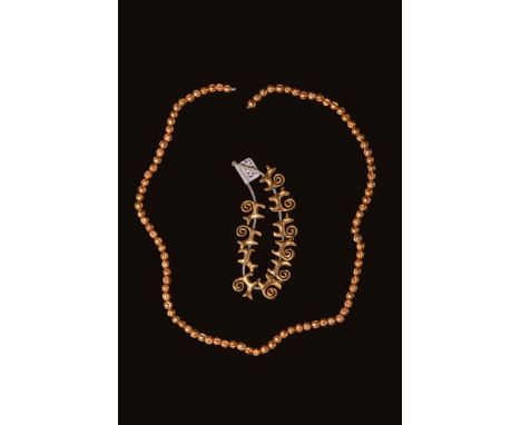 Late Period, Ca. 664 - 332 BC. A pair of strands of gold beads. The longer strand consists of small spherical beads with long