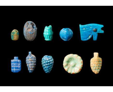 New Kingdom, Ca. 1550 - 1069 BC. A collection of amulets, pendants, and beads in faience and glass, including a faience hedge