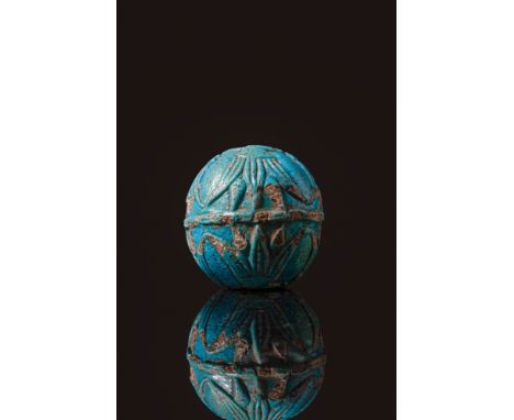 New Kingdom, 18th Dynasty, Ca. 1550 - 1069 BC. A spherical blue faience bead of substantial size, decorated in low relief wit