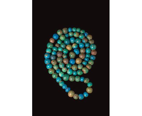 Middle Kingdom, Ca. 2055 - 1550 BC. A faience necklace restrung with spherical beads in shades of turquoise, green, and blue.