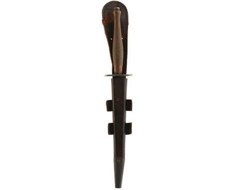 A SECOND PATTERN FAIRBAIRN SYKES COMMANDO KNIFE OR DAGGER, 17cm flattened diamond section blued blade, chequered brass grip, 
