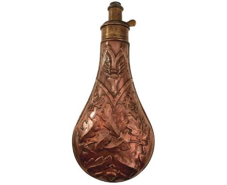 A LARGE SIZE EMBOSSED COPPER POWDER FLASK, decorated over all with oak leaves and stags' heads, the top stamped SYKES, gradua