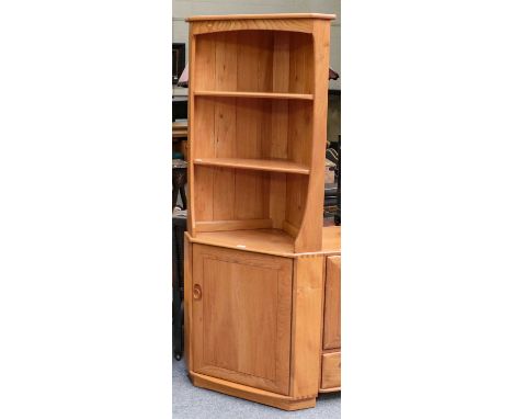 An Ercol Windsor style freestanding corner cupboard with shelves and cupboard door, 75cm by 40cm by 180cm