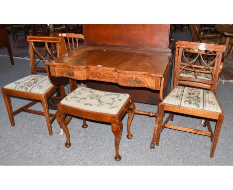 A reproduction crossbanded mahogany sofa table with drop leaves, 101cm closed by 60cm by 74cm, together with a pair of dining