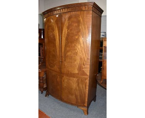 A walnut double wardrobe, 118cm by 70cm by 195cm, and a matching bedside table (2)Condition report: 2nd quarter 20th century.