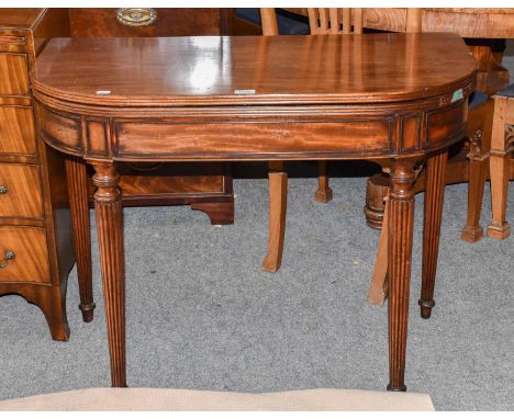 A mahogany foldover card table on tapering reeded legs, 92cm by 45cm by 72cm 