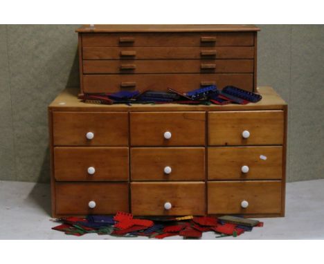 Meccano - Two wooden cabinets containing Meccano parts and accessories from the Mid 20th C onwards to include gears, wheels, 