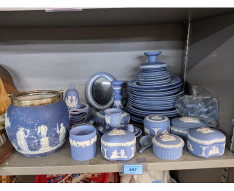 A collection of blue Wedgwood Jasperware items to include decorative wall plates, a photo frame, trinket boxes and candlestic